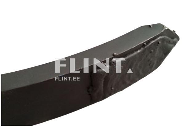 The product is black and has a notable oval shape. It features a smooth surface, with slightly uneven texture on one side.